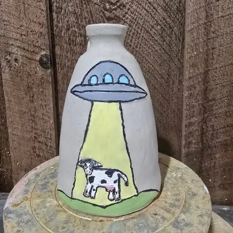 Handmade pottery jug painted with a cow being abducted by a UFO